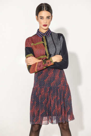Mini tiered skirt with dots with shirt arms crossed &bull; Sassa Björg